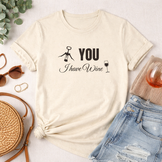 A cream wine t-shirt with a humorous wine-themed design, with text a graphic of a corkscrew and text 'you, I have Wine' 