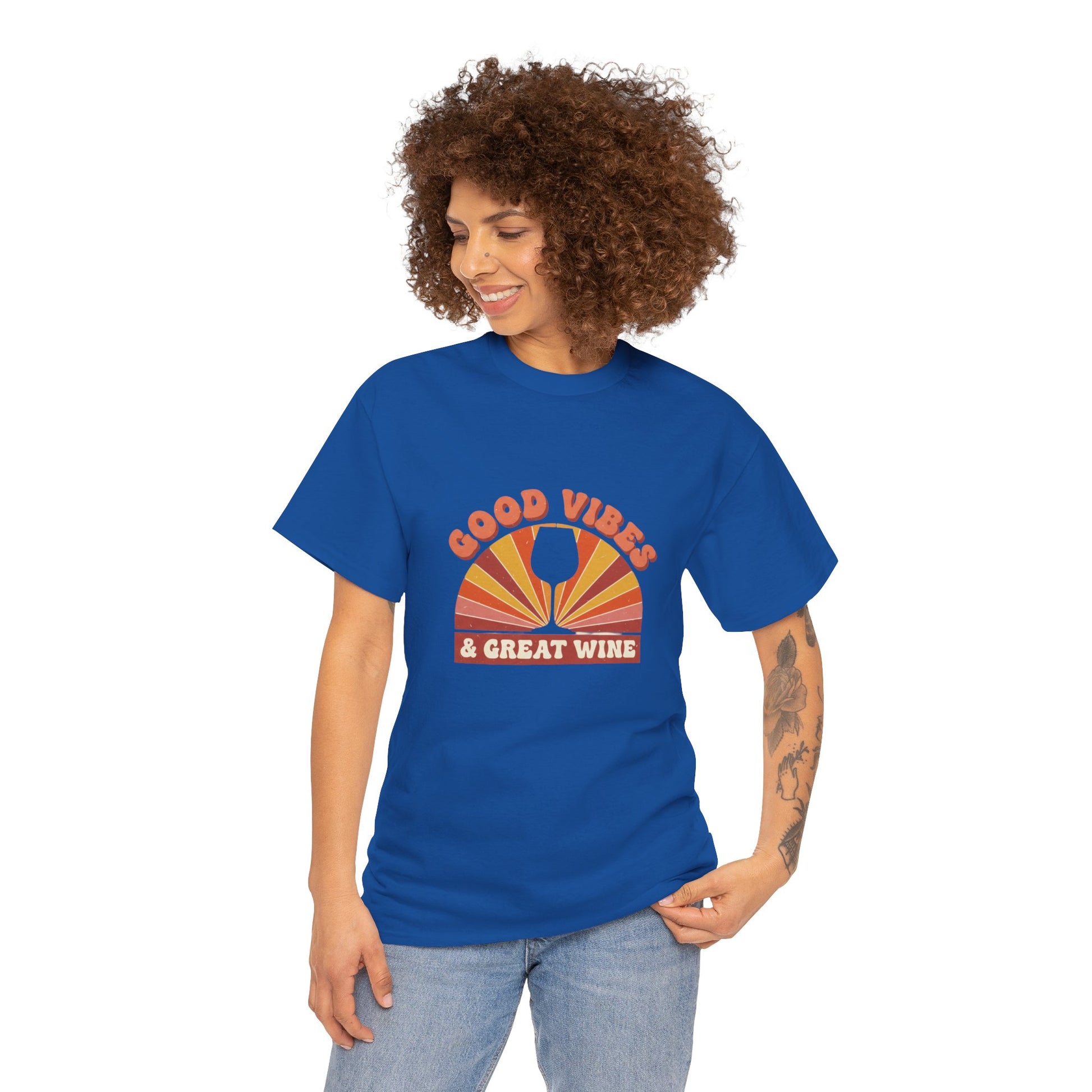 Person wearing blue T-shirt with a vintage graphic that states "good vibes and great wine" and white background