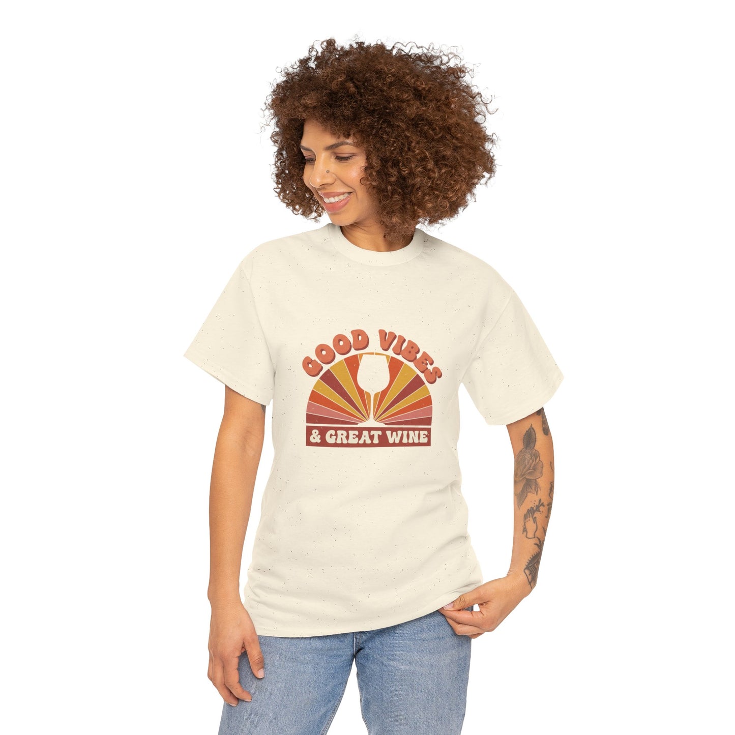 Person wearing natural color T-shirt with a vintage graphic that states "good vibes and great wine" and white background